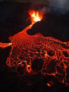 Spectacular view of Fagradalsfjall's lava flow at night, capturing the intense heat and vibrant colors.