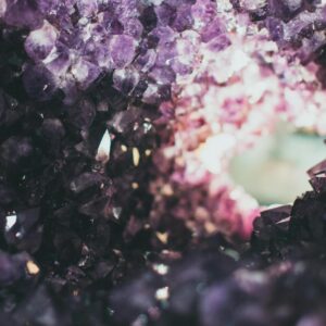 Macro photo of a rough amethyst geode with a tunnel view, showcasing vibrant purple crystals.